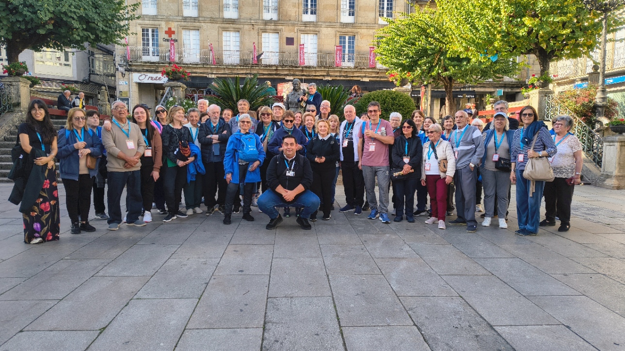 Grupo en la Plaza Mayor de Carballiño con la Vera Cruz al fondo